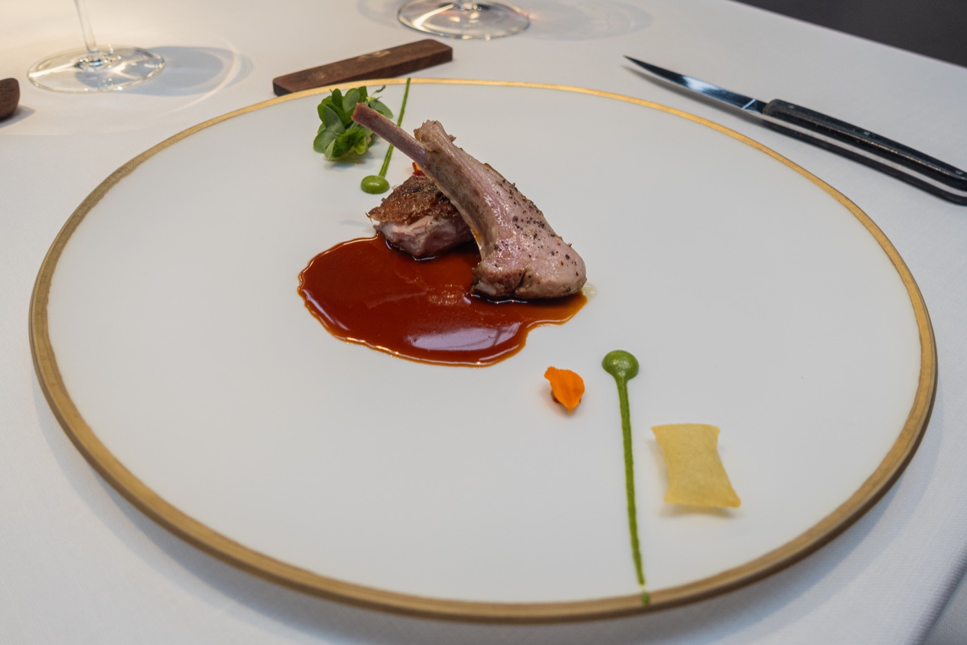 Aged suckling lamb with herbs, Padrón peppers, soufflé potatoes and ají. Spring.