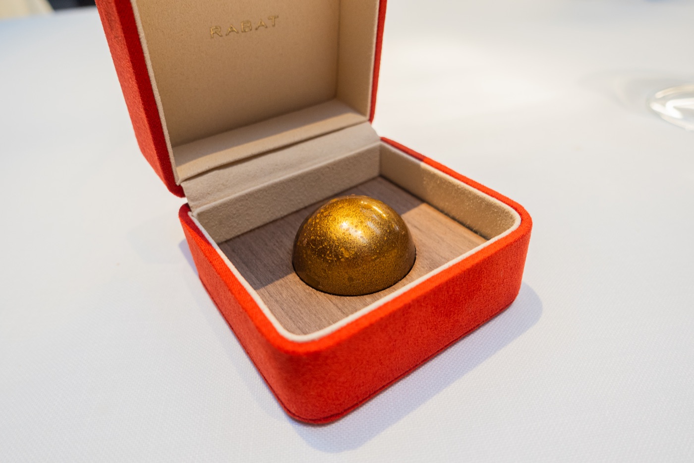 The Jewel. For you. A gold sphere in a red box.